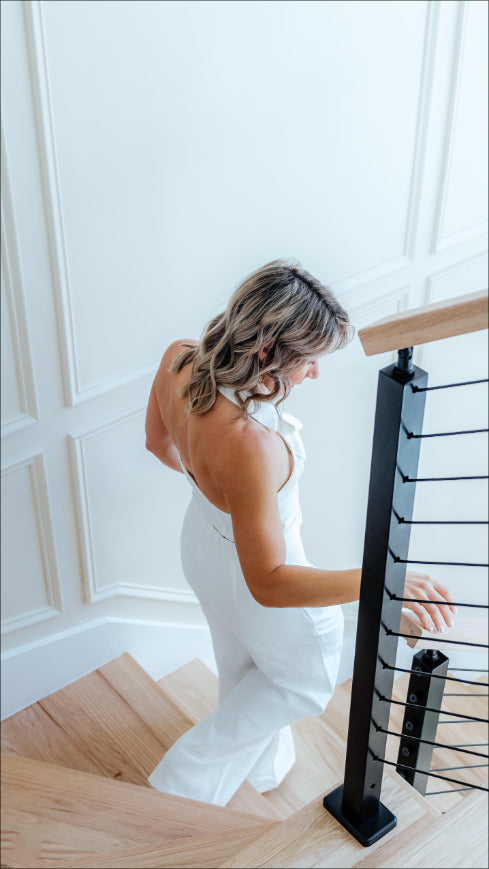 A Woman walking on the stair railing