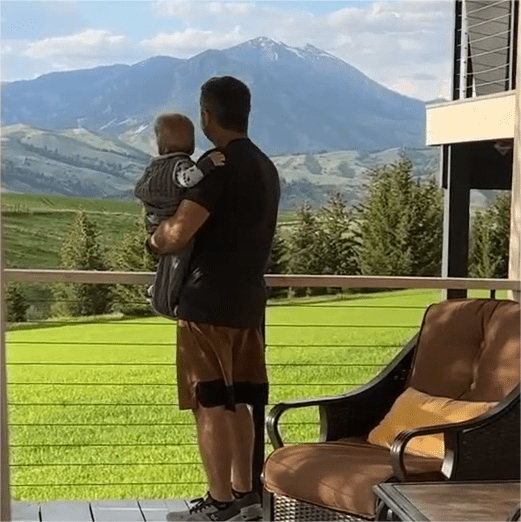 While holding his youngest child, Pete feels protected by the Muzata cable railing that provides ample safety and security