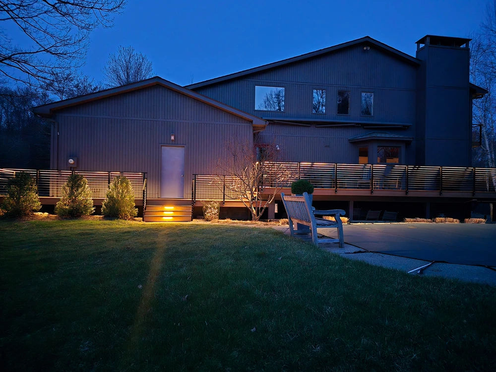 cable-deck-railings-on-a-stylish-patio-with-a-bench-at-night