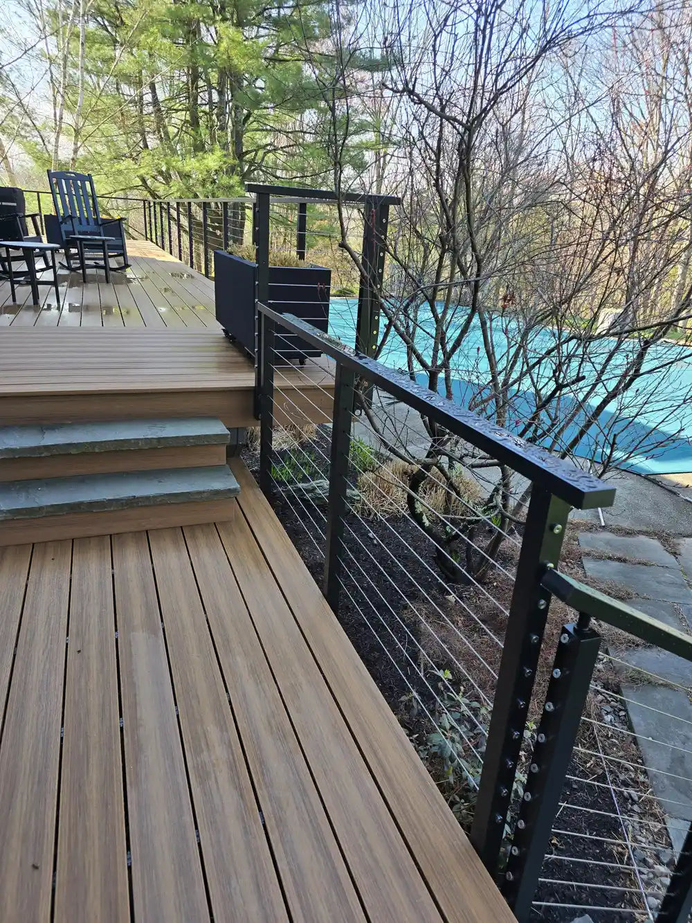 cable-deck-railings-on-an-elegant-deck-with-greenery