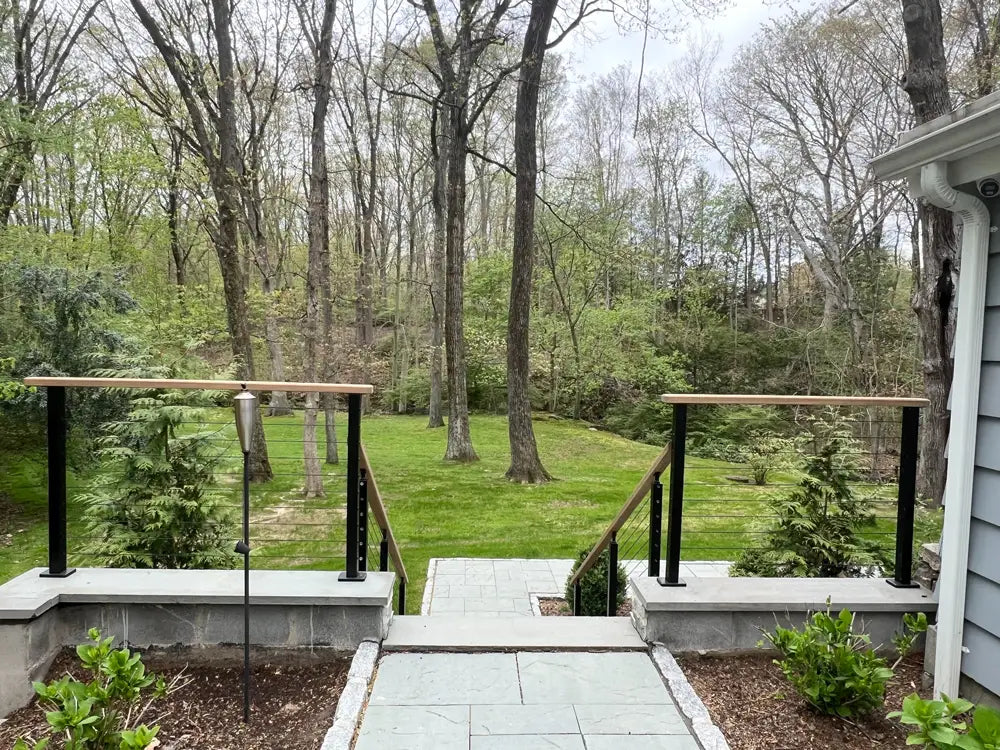 cable-infill-on-concrete-stair-railing-with-wooden-handrail