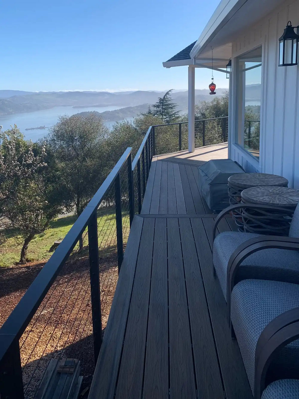 contemporary-deck-with-outdoor-cable-railing-and-hill-landscape