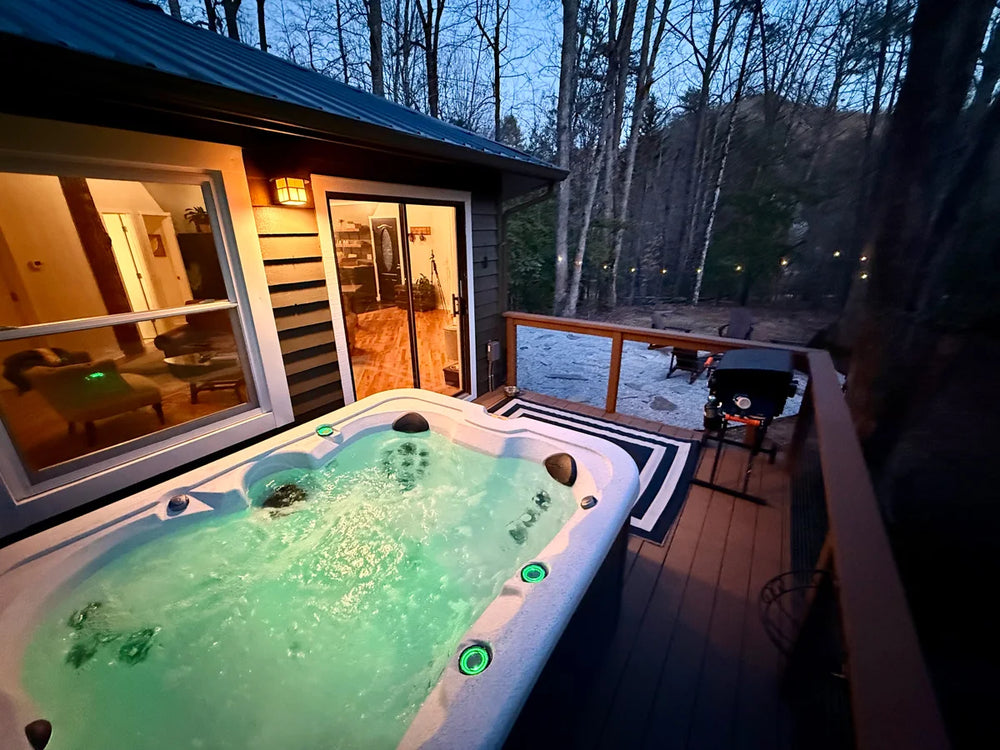 evening-view-of-the-cabins-wood-deck-cable-railing-and-lit-interior