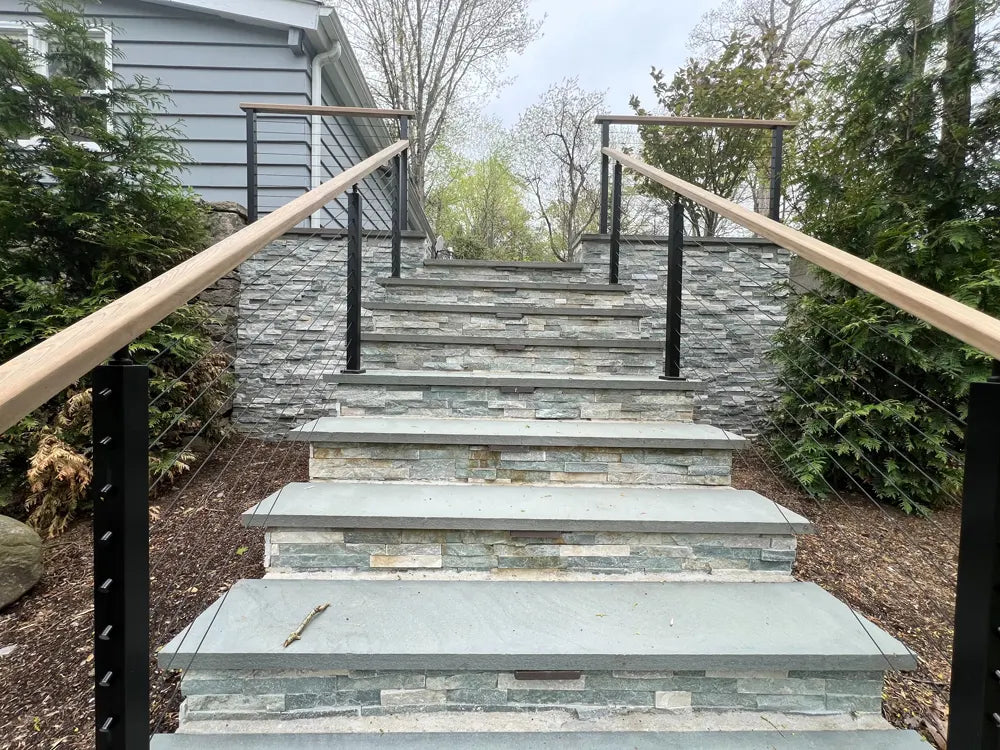 front-view-of-outdoor-concrete-stair-railing-with-tensioned-stainless-cables