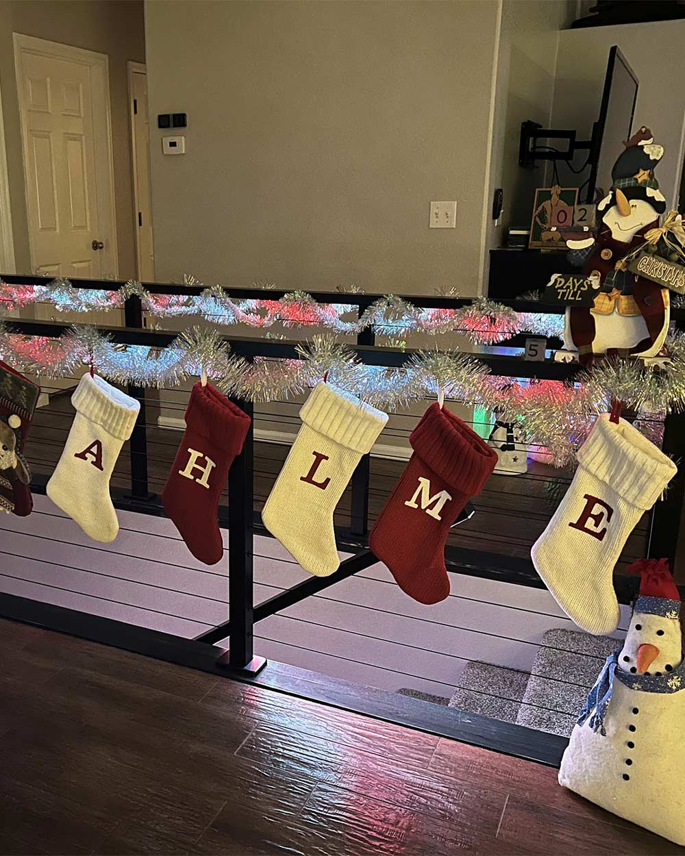 indoor cable railing with led lighted handrail and festive holiday tinsel display