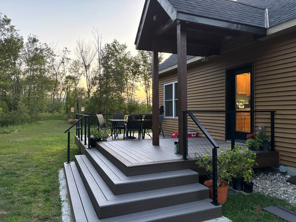 modern wood deck with black railing at sunset