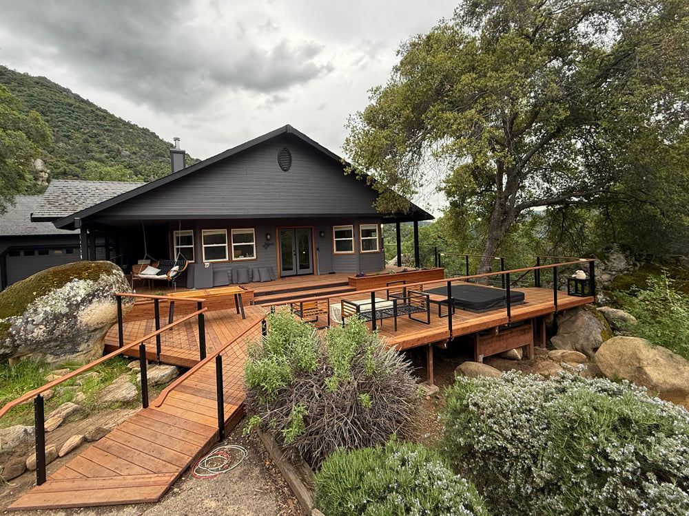 modern mountain home with cable railing for decks and wooden ramp.