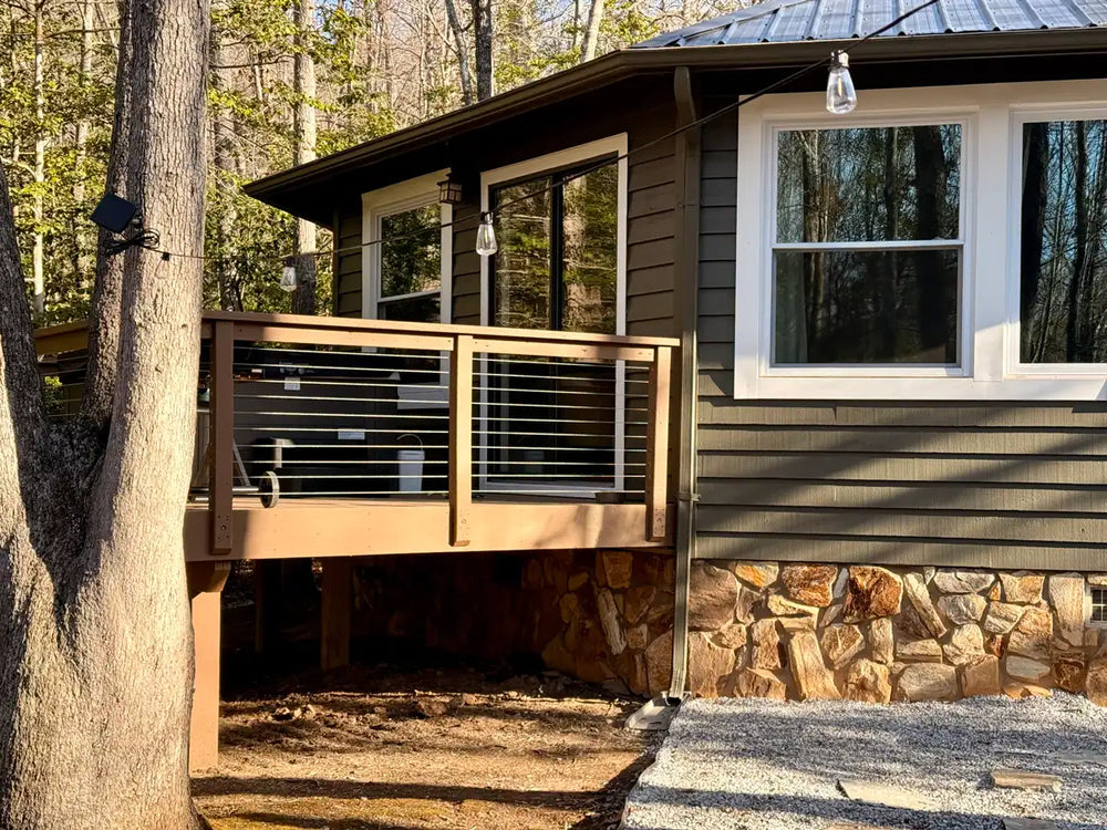 side-view-of-wood-deck-cable-railing-attached-to-cabin