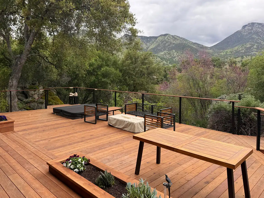 spacious wooden deck with cable railing for decks and seating area